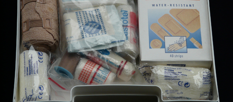 OSHA first aid kit containing bandages, gauze, gloves, and other workplace supplies