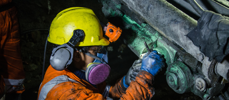 Industrial worker wearing a tight-fitting half-mask respirator on the job site